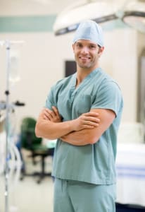 ortrait of smiling surgeon standing arms crossed in operation room