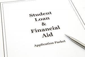 A student loan and financial aid college application packet with a pen ready to start.