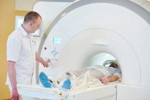 AN MRI Technician assisting a patient with an MRI scan.