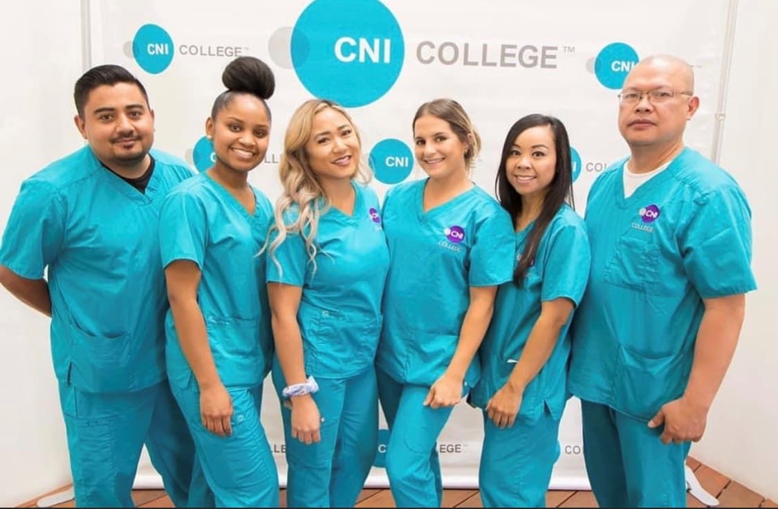 A group of 6 CNI College nursing and healthcare career students in front of a CNI College sign.