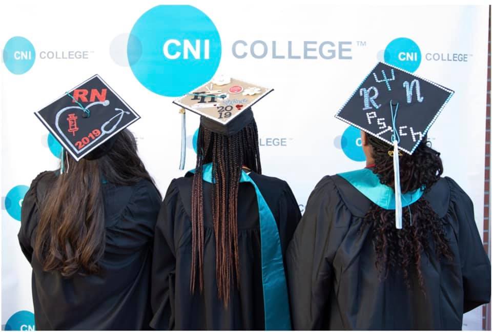CNI students with decorated graduation caps.