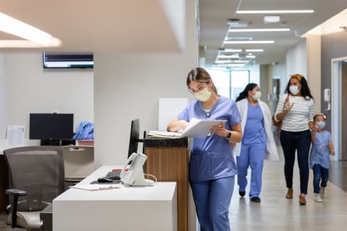 Nurse in a hospital reviewing documents at a desk