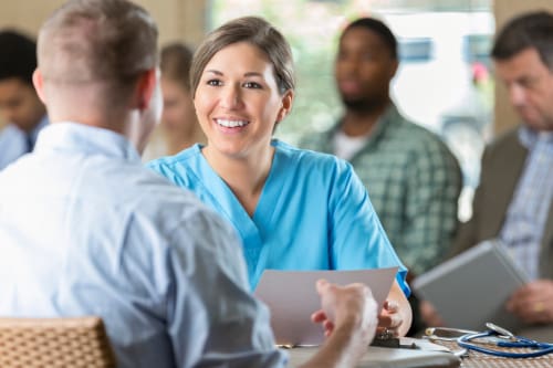 Potential student interviewing with admissions at a nursing school.