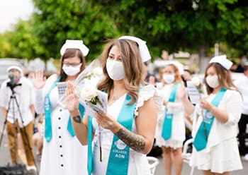 A group of nurses standing during their pinning ceremony