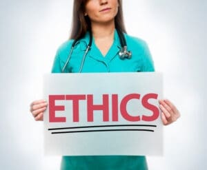 Nurse holding a sign that says ethics.