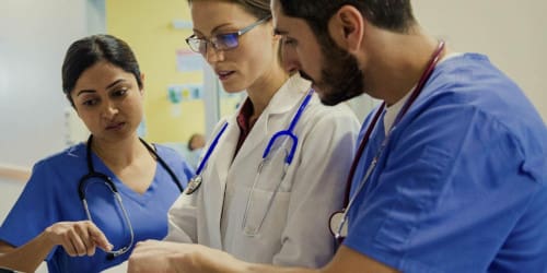 An MSN student working with two other nurses