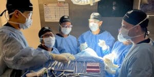 A group of surgical technology students practicing with instruments