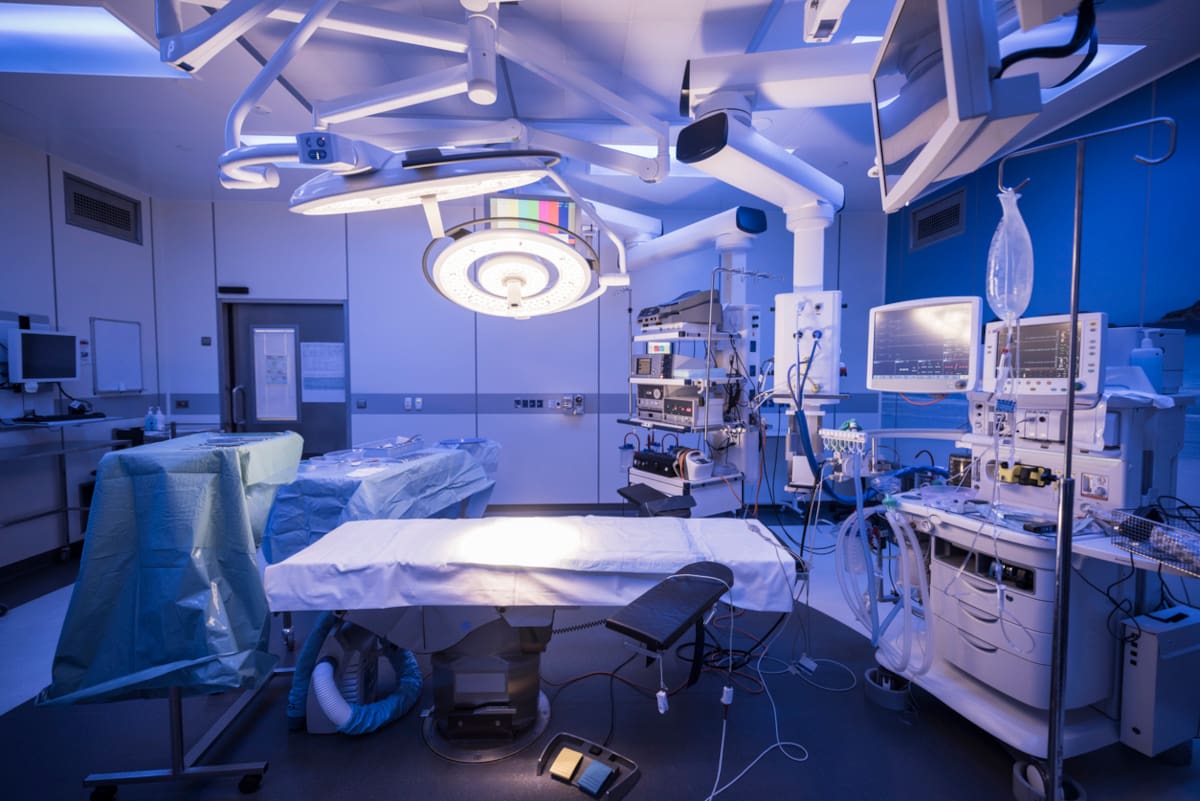 An operating room with the lights on but without people