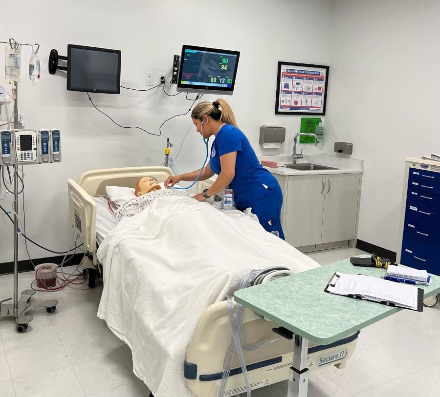 A nursing student working with simulation equipment